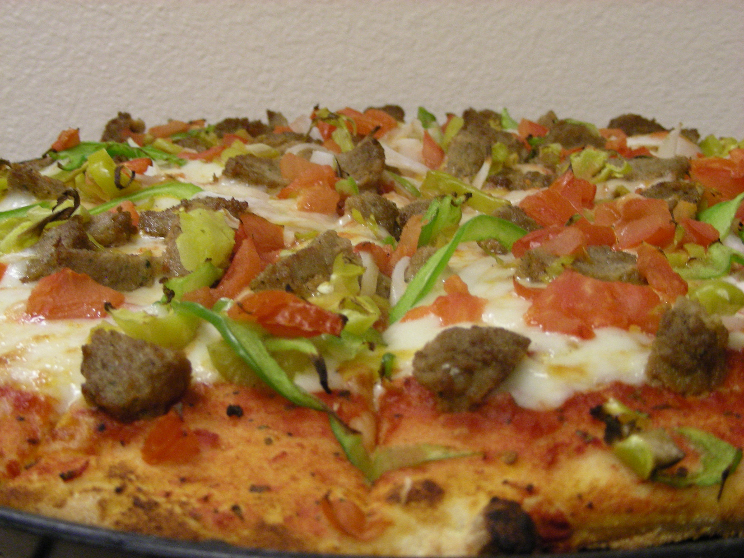 Spicy Meatball Pizza (Italian Meatballs, Pepperoncini Peppers, Diced Tomatoes, Onion, and Green Pepper.)