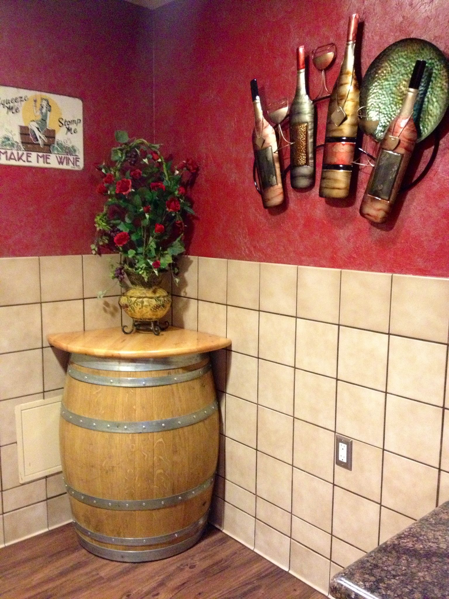 A peek into the women's restroom decorated with an old wine barrel and wine related decor